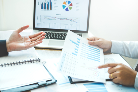 Co-working Business Team meeting Planning Strategy Analysis investment and saving concept. meeting discussing new plan financial graph data.の写真素材