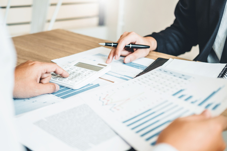 Co-working Business Team meeting Planning Strategy Analysis investment and saving concept. meeting discussing new plan financial graph data.の写真素材