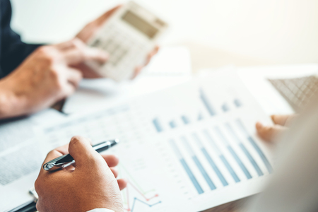 Co-working Business Team meeting Planning Strategy Analysis investment and saving concept. meeting discussing new plan financial graph data.の写真素材