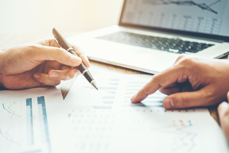 Co-working Business Team meeting Planning Strategy Analysis investment and saving concept. meeting discussing new plan financial graph data.の写真素材