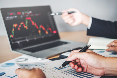 Business Team Investment Entrepreneur Trading discussing and analysis graph stock market...