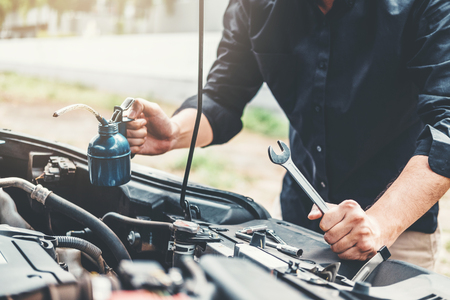 Auto mechanic working in garage Technician Hands of car mechanic working in auto repair Service and Maintenance car check.の写真素材