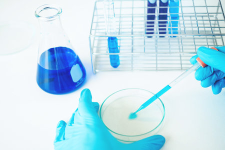 Scientist with equipment holding tools during scientific experiment science concept