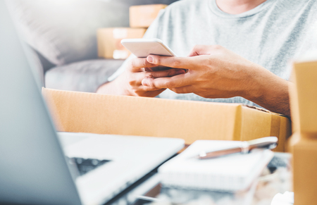 SME freelance man working with packaging startup entrepreneur small business owner at home,Online business seller packaging and delivery conceptの写真素材