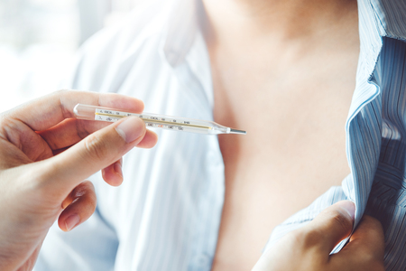 Doctor holding on thermometer for checking sick patient Health care in hospitalの写真素材