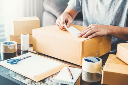 SME freelance man working with packaging startup entrepreneur small business owner at home,Online business seller packaging and delivery conceptの写真素材
