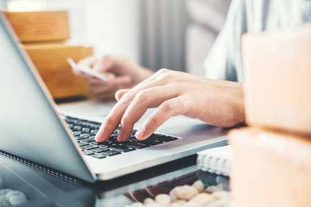 SME freelance man working with packaging startup entrepreneur small business owner at home,Online business seller packaging and delivery conceptの写真素材