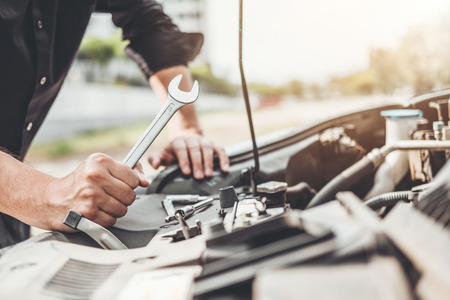 Auto mechanic working in garage Technician Hands of car mechanic working in auto repair Service and Maintenance car check.の写真素材