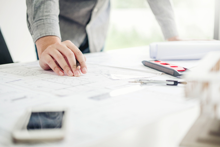 Architect or engineer working in office on blueprint. Architects workplaceの写真素材