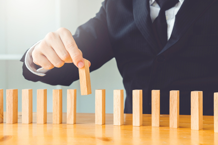 Businessman plan and strategy in business Domino Effect Problem Solvingの写真素材