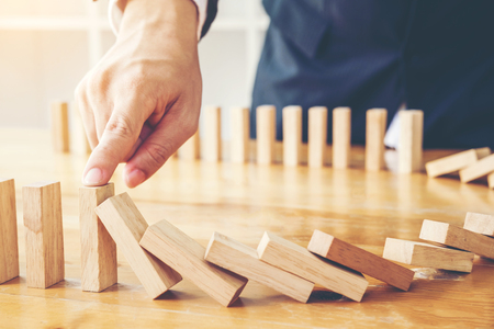 Businessman plan and strategy in business Domino Effect Problem Solvingの写真素材