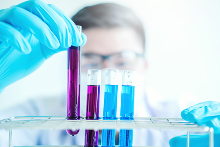 Scientist with equipment holding tools during scientific experiment science conceptの写真素材