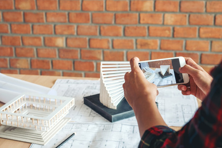 Architect or engineer working in office on blueprint. Architects workplaceの写真素材