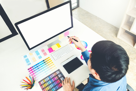 Graphic designer drawing on graphics tablet at workplaceの写真素材