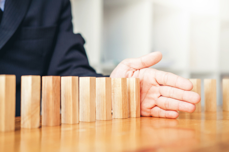 Businessman plan and strategy in business Domino Effect Problem Solvingの写真素材