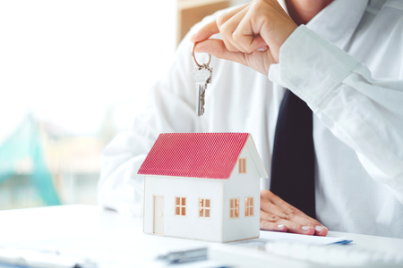 Sale agent giving Key house to customer and sign agreement contract, Insurance Home conceptの写真素材