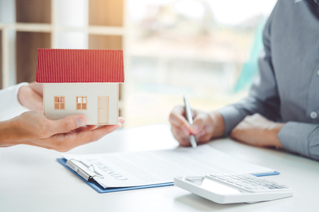 Sale agent giving house to customer and sign agreement contract, Insurance Home conceptの写真素材
