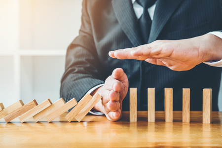 Businessman plan and strategy in business Domino Effect Problem Solvingの写真素材