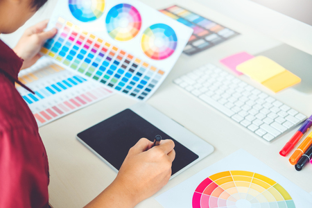 Graphic designer drawing on graphics tablet at workplaceの写真素材