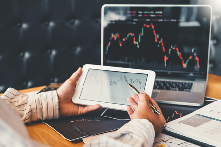Investment stock market Entrepreneur Business Man using tablet discussing and analysis graph stock market trading,stock chartの写真素材