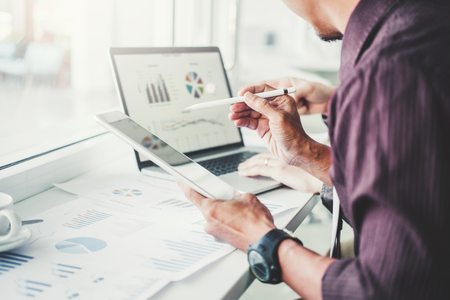 Co-working Business Team Consulting meeting Planning with digital tablet Strategy Analysis investment and saving concept. meeting discussing new plan financial graph data.の写真素材