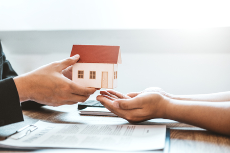 Sale agent giving house to customer and sign agreement contract, Insurance Home conceptの写真素材