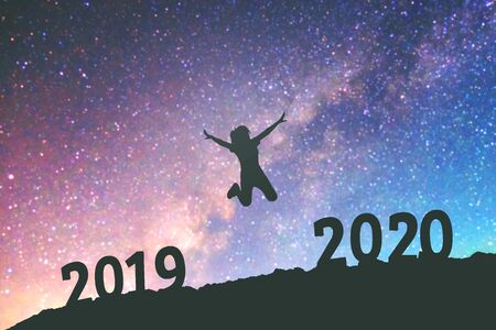 Silhouette young woman Happy for 2020 new year background on  the Milky Way galaxyの写真素材