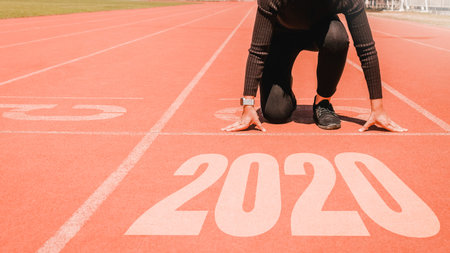 2020 Newyear , Athlete Woman starting on line for start running with number 2020 Start to new year.