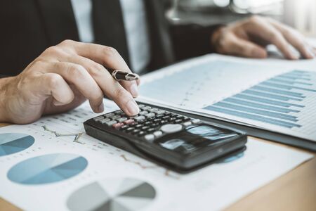 Business man Accounting Calculating Cost Economic budget putting Row and coin Write Finance ,investment and saving conceptの写真素材