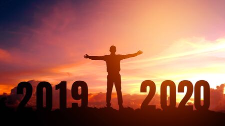 Silhouette young Business man happy to 2020 new year success concept.の写真素材