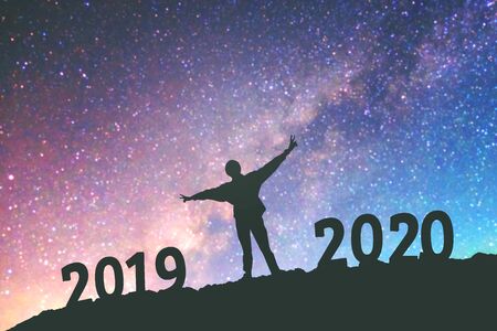 Silhouette young man Happy for 2020 new year background on  the Milky Way galaxyの写真素材