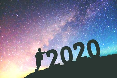 Silhouette young man Happy for 2020 new year background on  the Milky Way galaxyの写真素材