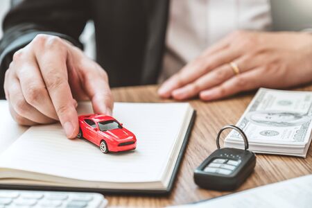Sale agent giving Car to customer and sign agreement contract, Insurance car concept.の写真素材