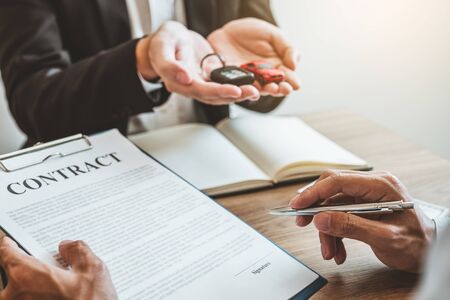 Sale agent  deal to agreement successful car loan contract with customer and sign agreement contract  Insurance car concept.の写真素材