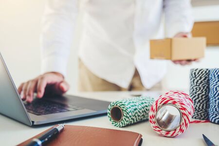 SME freelance man working with packaging startup entrepreneur small business owner at home,Online business seller packaging and delivery conceptの写真素材