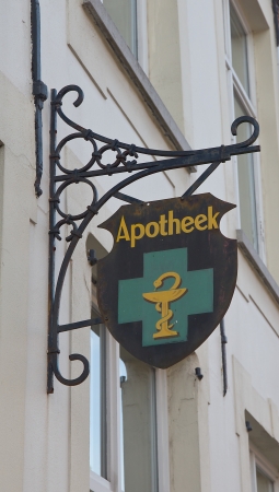 Retro style signboard of a pharmacy on the street of historic center of Bruges  UNESCO World Heritage Site , West Flanders, Belgium のeditorial素材