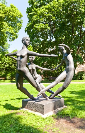 Riga, Latvia - May 25, 2014  Sculpture of three dancing women  Dance World, circa 1970s  in Bastion Hill  Bastejkalns  park of Riga, Latvia  Work of sculptor Parsla Zalkalnsのeditorial素材