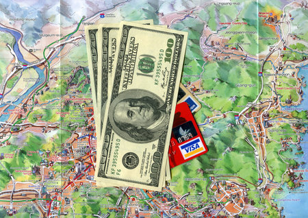 Concept traveling to Busan (South Korea). USA dollars, Visa credit cards, Busan city map