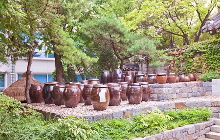 SEOUL, SOUTH KOREA - SEPTEMBER 28, 2014: Korean traditional earthenware jars Onggi in Namsangol Hanok Village museum of Seoul, Korea. Onggi used as storage containers of sauces and fermented foodsのeditorial素材