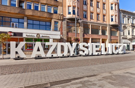 LODZ, POLAND - OCTOBER 19, 2014: Huge white letters KAZDY SIE LICZY (Everyone counts) on central Piotrkowska Street in Lodz, Poland. Out-door photo exhibition commemorates the 100th anniversary of the Polish Legionsのeditorial素材