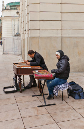 WARSAW, POLAND - OCTOBER 18, 2014: Two street musicians play cimbalom (hammered dulcimer) on...