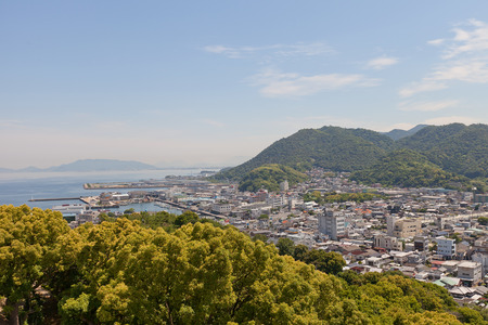 SHIKOKUCHUO, JAPAN - MAY 22, 2015: View of Kawanoe town and port from Kawanoe castle in Shikokuchuo city, Shikoku Island, Japan. Shikokuchuo is the leading producer of paper and paper products in Japanのeditorial素材