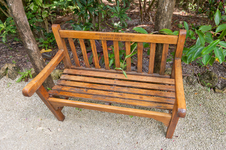 GRAND CAYMAN - JUNE 28, 2015: Commemorative bench in Queen Elizabeth II Botanic Park of Grand Cayman, Cayman Islands (British Overseas Territory). Made in memory of David Foster (1942-2005), founder of Foster Food Fair companyのeditorial素材