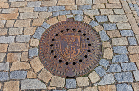 KUTNA HORA, CZECH REPUBLIC - NOVEMBER 04, 2015: Decorated sewer manhole in Kutna Hora, Czech Republic. Depicts coat of arms of Kutna Hora townのeditorial素材