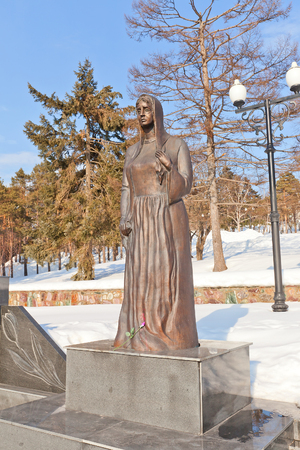 YUZHNO-SAKHALINSK, RUSSIA - MARCH 17, 2016: Statue Grieving Mother, part of the memorial (circa 2004) for Russian soldiers killed in Afghanistan and Chechnya conflicts. Sculptor Vladimir Chebotarevのeditorial素材