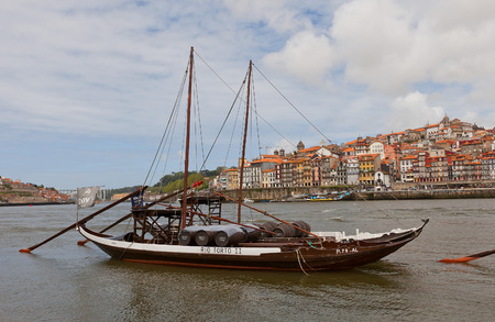 PORTO, PORTUGAL - MAY 25, 2016: Traditional Rabelo boats (used for port wine transportation) on Douro River in Porto, Portugal. Historical part of Porto city at the backgroundのeditorial素材