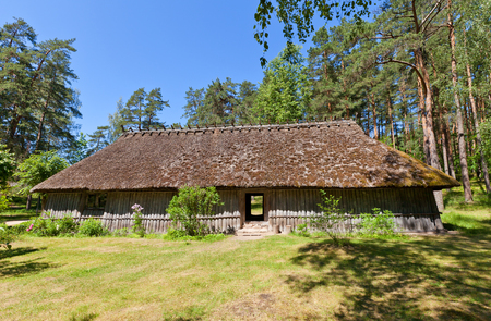 RIGA, LATVIA - JUNE 13, 2016: Fisherman chimneyless dwelling house (circa 1750s) of Kursi farmstead of Kurzeme ethnic group. Exhibited in Ethnographic Open-Air Museum of Latvia since 1939のeditorial素材