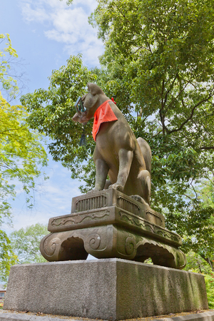 KYOTO, JAPAN - MAY 17, 2017: Statue of kitsune with a key in Fushimi Inari Taisha Shinto Shrine in Kyoto, Japan. Kitsune is a fox shapeshifter and a servant of Inari goddessのeditorial素材