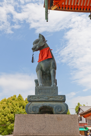 KYOTO, JAPAN - MAY 17, 2017: Statue of kitsune with a key in Fushimi Inari Taisha Shinto Shrine in Kyoto, Japan. Kitsune is a fox shapeshifter and a servant of Inari goddessのeditorial素材