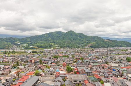 KAMINOYAMA, JAPAN - MAY 28, 2017: View of Sankichiyama Mount and Kaminoyama City from donjon of Kaminoyama Castle. Modern Kaminoyama was established in 1889, and was elevated to city status in 1954のeditorial素材